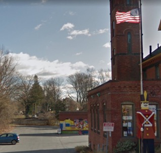 Figure 6 – Image of the Amazing Things Arts Center parcel, behind which a fence without an MWRA permit blocks bicyclists and pedestrians from traveling along the Sudbury Aqueduct. Figure 6 – Image of the Amazing Things Arts Center parcel, behind which a fence without an MWRA permit blocks bicyclists and pedestrians from traveling along the Sudbury Aqueduct.